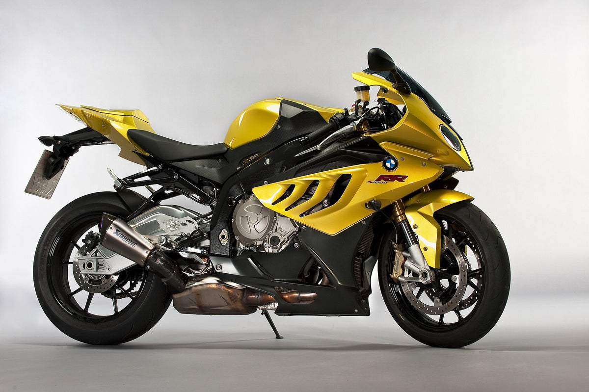 Real yellow and black BMW S1000RR photographed against a clean light background, showing nose, side and lower fairings