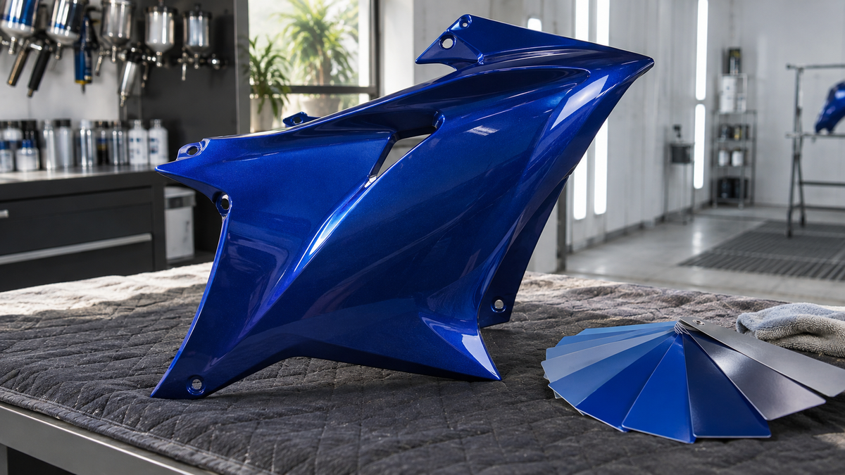 AI concept of a blue fairing panel with paint sample cards in a refinishing studio; not an exact Yamaha part.