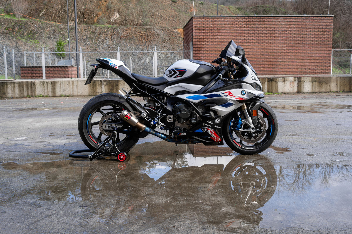 Real BMW sport motorcycle parked on wet pavement, shown as exposure context rather than evidence of salt damage