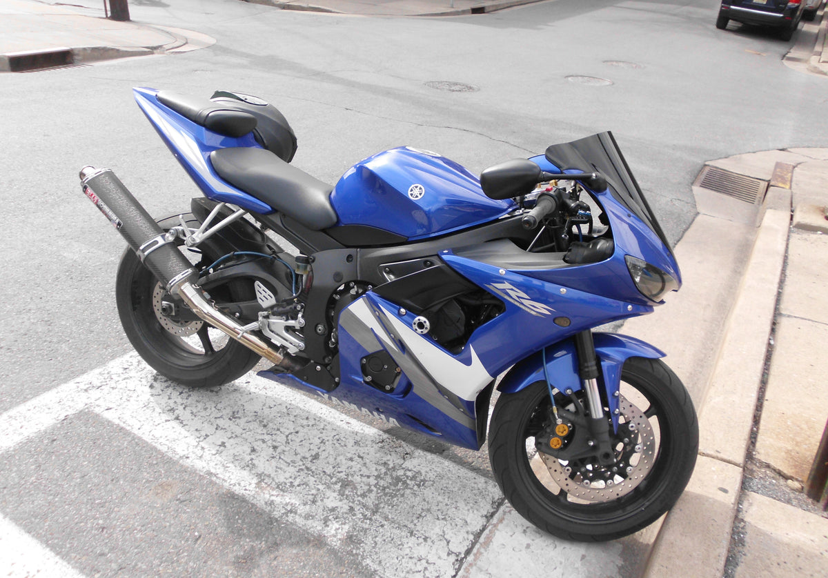 Real blue Yamaha YZF-R6 parked outdoors on a street; editorial photo, not a crash scene or NiceFairings product