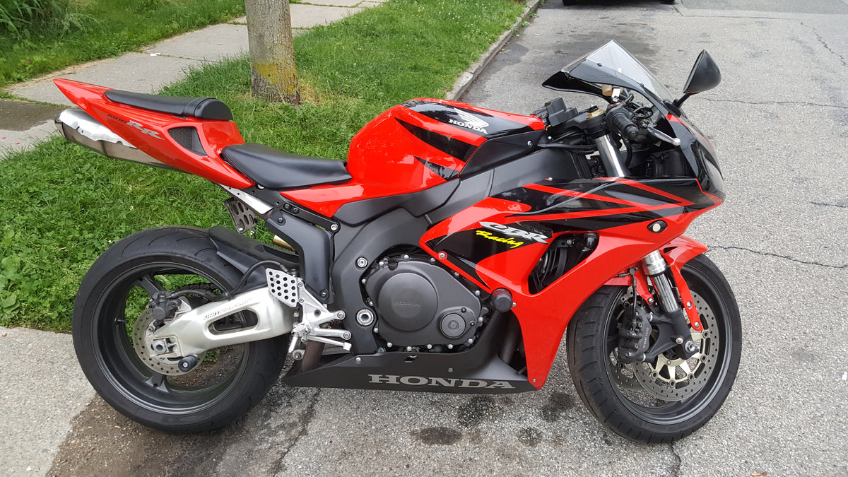 Real red 2006 Honda CBR1000RR Fireblade photographed outdoors by Awalcant, CC BY-SA 4.0; unmodified editorial image, not a NiceFairings product