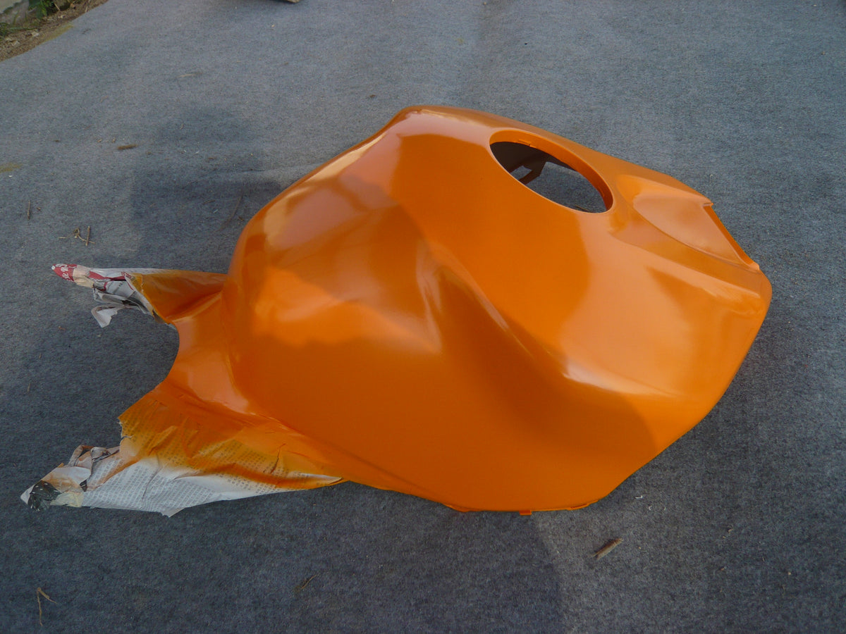 NiceFairings production photograph of an orange painted tank-cover panel with masking paper