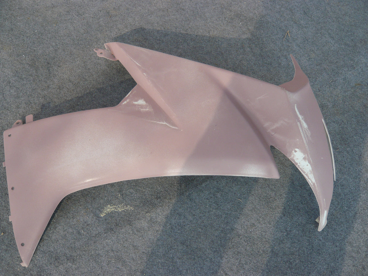 Real motorcycle fairing side panel during surface preparation in the NiceFairings workshop; this photo does not establish the plastic grade or forming process