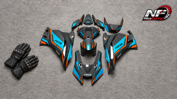 Owner-supplied black, cyan and orange YZF-R9 fairing-panel flat lay with AI-added unbranded riding gloves and small NiceFairings logo; editorial visual, not slider-fitment evidence