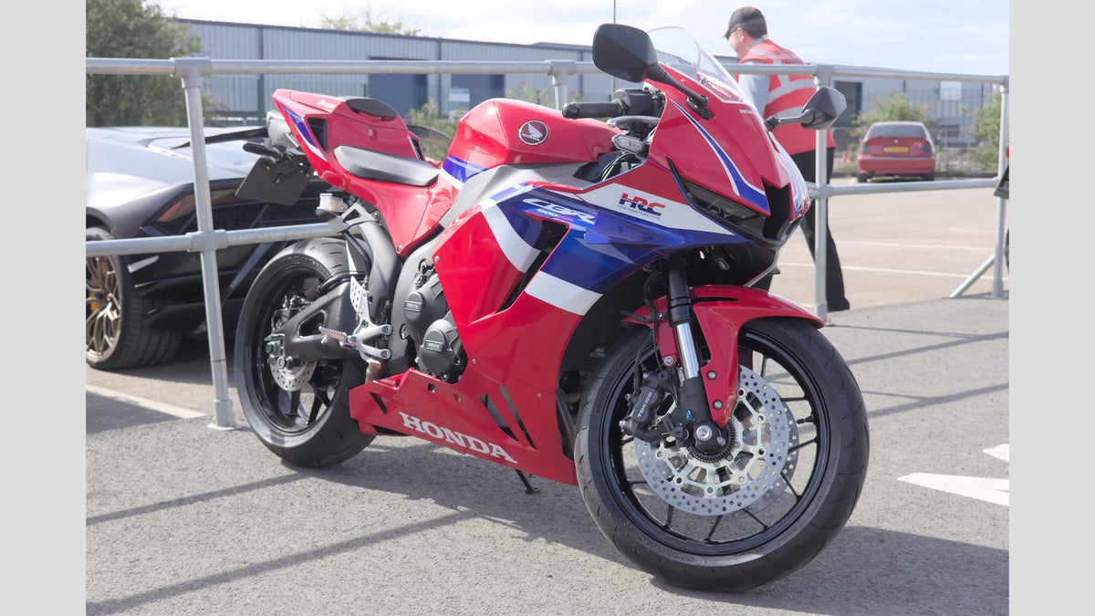 Real red 2024 Honda CBR600RR photographed outdoors in the United Kingdom by Aethonatic, CC0; full bike shown with plain side margins; not a U.S. 2027 model or NiceFairings installation