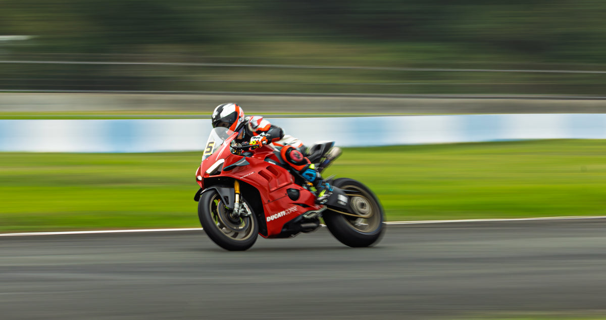 Real Ducati Panigale V4 rider at Clark International Speedway during a 2025 track day; photo by Monkinvideos, CC BY-SA 4.0, not a NiceFairings product