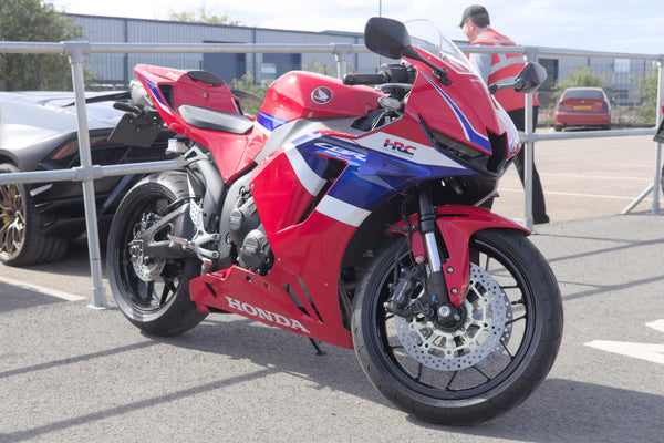 Real red white and blue Honda CBR600RR parked outdoors, an independent CC0 photograph rather than a 2026 MotoGP or NiceFairings product image