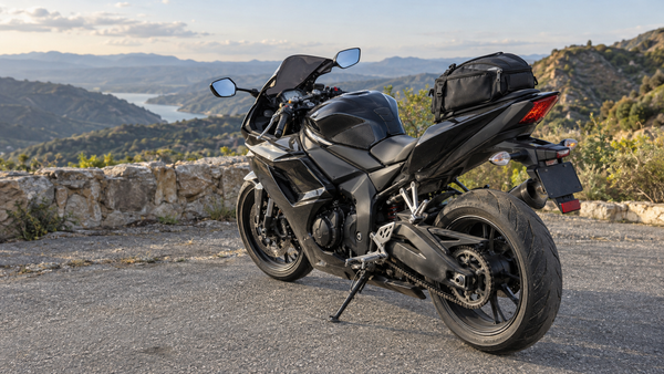 AI editorial concept of a complete black sport motorcycle parked at a scenic overlook with a soft tail bag on the passenger-seat area; not a real installation or NiceFairings product